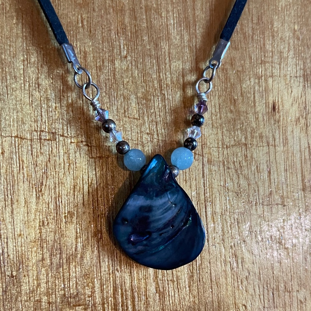 Abalone shell necklace with beaded leather cord.